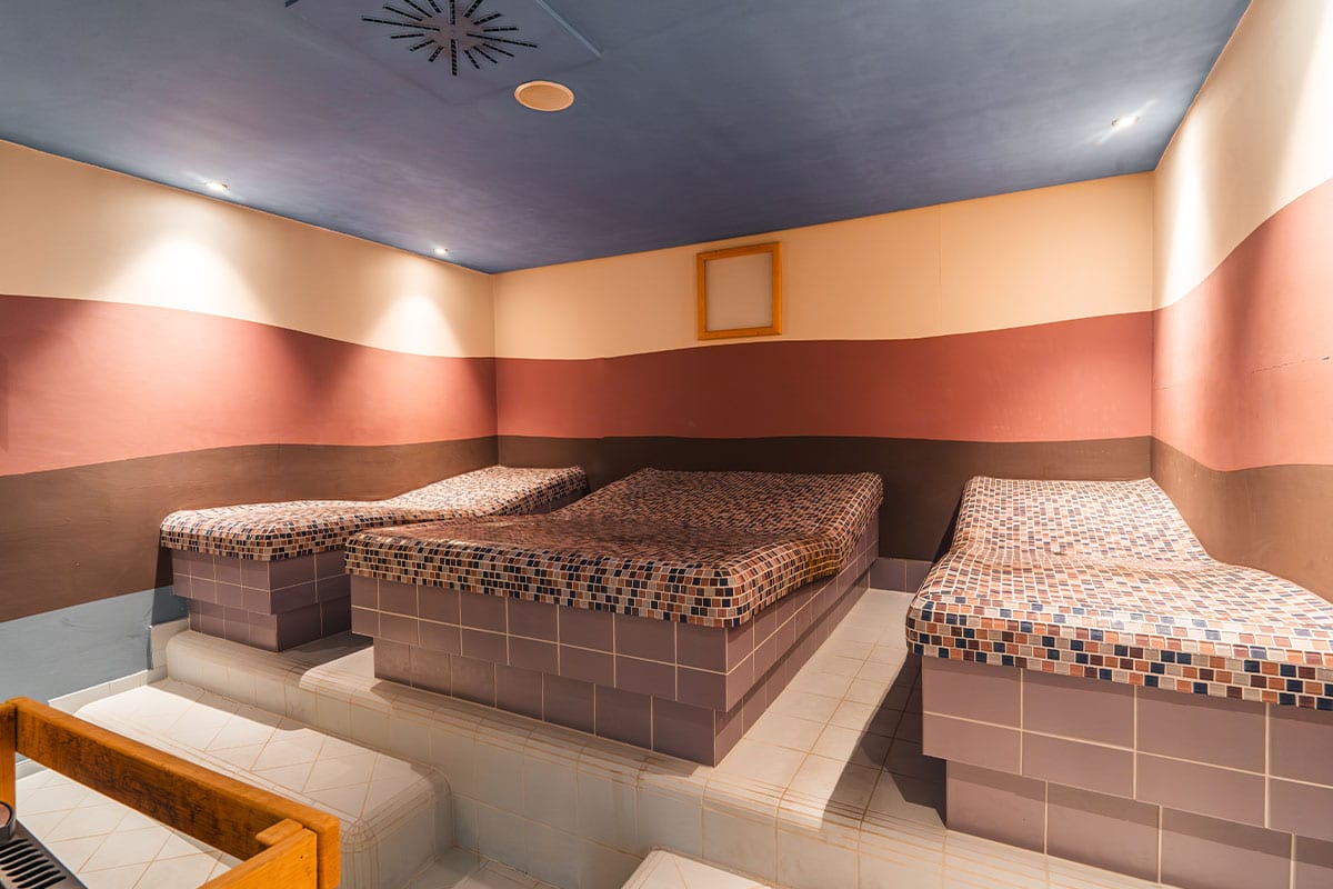 Steam bath with heated stone loungers in the spa area of Grand Hotel Binz