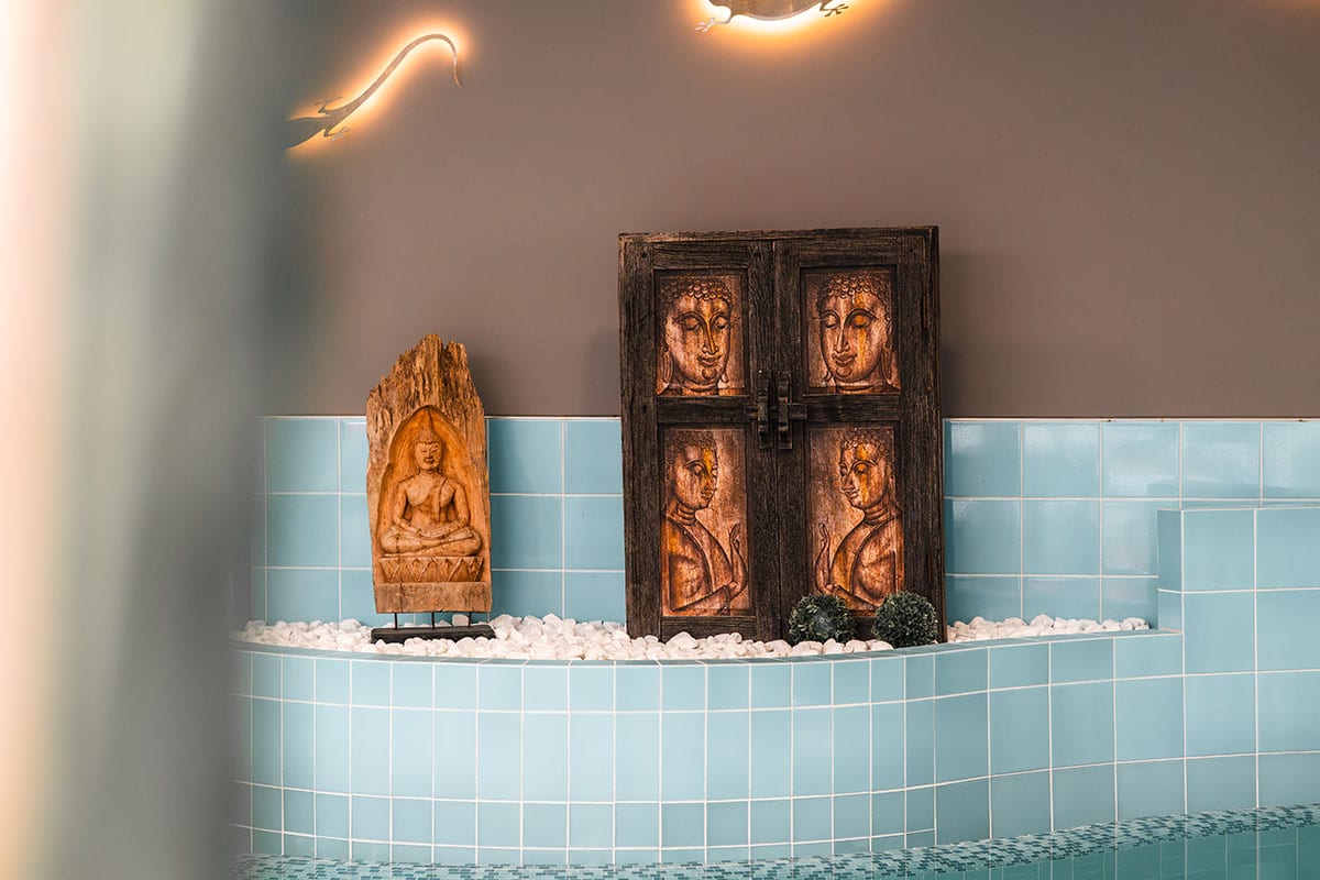 Wooden carvings and Buddha figures in the pool area