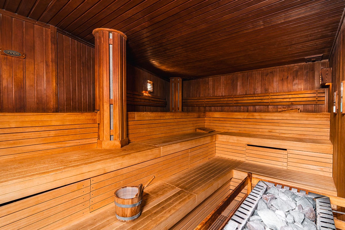 Classic Finnish sauna with wood paneling, sauna bucket and hot stones for infusions